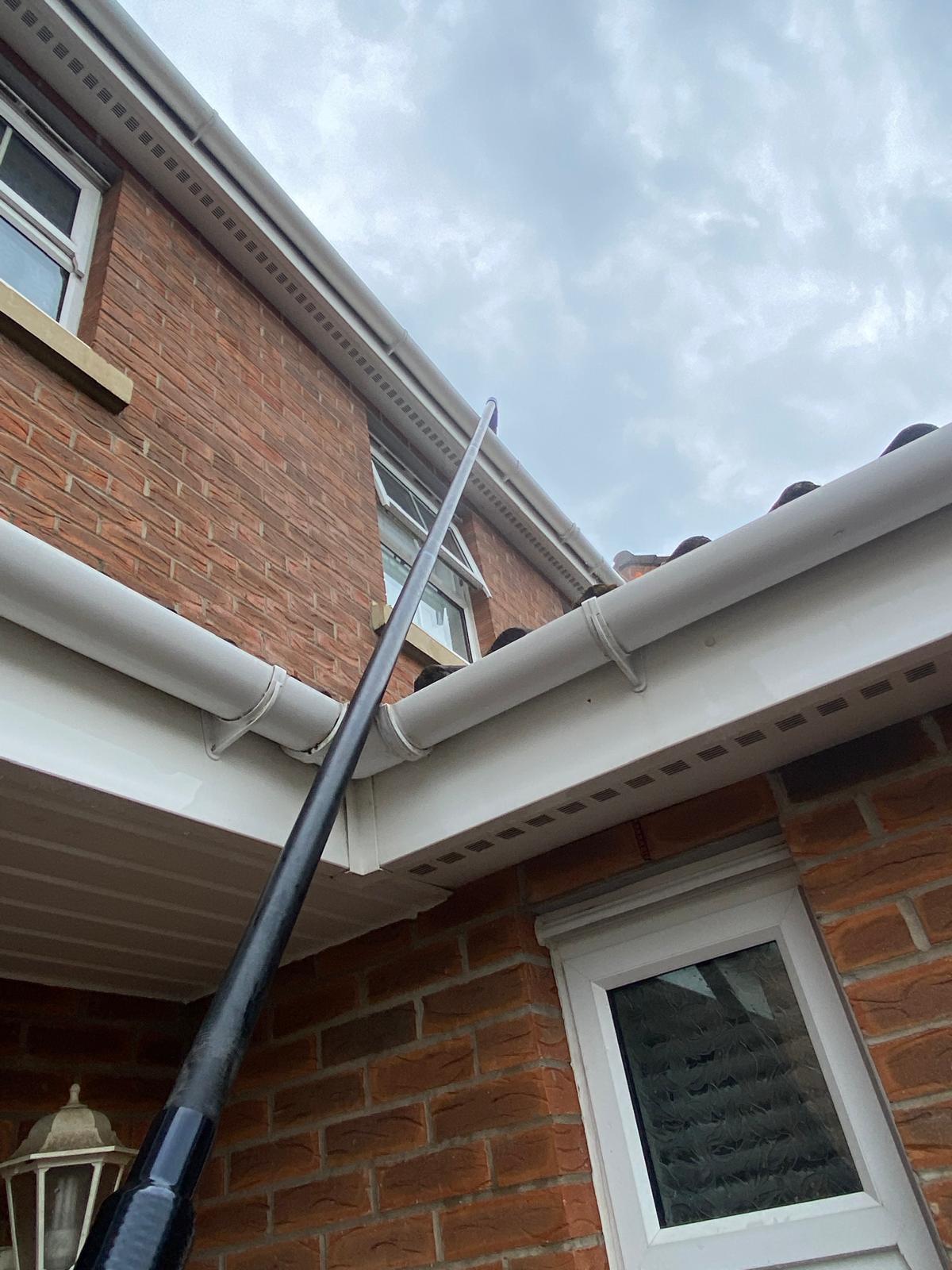 A window being cleaned from an awkward angle.